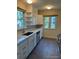 Modern kitchen with white cabinets, countertops, and stainless steel appliances at 2634 S Humboldt St, Denver, CO 80210