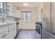Well-lit kitchen features stainless steel appliances, white cabinetry, and a bright window at 2634 S Humboldt St, Denver, CO 80210