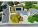 This aerial showcases a home with a large front yard, solar panels, and a 2-car driveway at 1606 S Flanders Way, Aurora, CO 80017