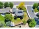 Bird's eye view of a home with solar panels, a well-kept lawn, mature trees, and a fenced yard at 1606 S Flanders Way, Aurora, CO 80017