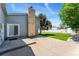 Large backyard featuring a well-kept lawn, a tall brick chimney, and a concrete patio at 1606 S Flanders Way, Aurora, CO 80017
