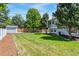 Spacious backyard featuring mature trees, a storage shed and a lush, green lawn at 1606 S Flanders Way, Aurora, CO 80017