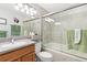 Well-lit bathroom featuring a granite countertop, shower with sliding glass door, and a large mirror at 1606 S Flanders Way, Aurora, CO 80017