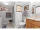 Traditional bathroom with neutral tones and tile flooring next to the laundry room at 1606 S Flanders Way, Aurora, CO 80017