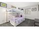 This cozy bedroom features a cute bunkbed with a playful purple theme at 1606 S Flanders Way, Aurora, CO 80017