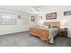 Serene bedroom with soft gray walls, plush carpeting, a ceiling fan, and a large window, creating a relaxing retreat at 1606 S Flanders Way, Aurora, CO 80017