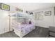 Bedroom with a white bunk bed, grey carpet, and natural light from the window at 1606 S Flanders Way, Aurora, CO 80017