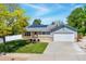 Charming single-story home featuring solar panels, a well-manicured lawn, and an attached two-car garage at 1606 S Flanders Way, Aurora, CO 80017