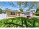 Charming home with a brick facade, well-manicured lawn, and mature trees in a sunny setting at 1606 S Flanders Way, Aurora, CO 80017