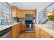 A kitchen features stainless steel appliances, granite countertops, hardwood floors and wood cabinetry at 1606 S Flanders Way, Aurora, CO 80017
