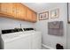 Spacious laundry room with overhead cabinets and full sized washer and dryer at 1606 S Flanders Way, Aurora, CO 80017