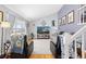 Cozy living room featuring hardwood floors, neutral-toned walls, large windows, and comfortable seating arrangements at 1606 S Flanders Way, Aurora, CO 80017