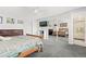 This primary bedroom has carpeted floors, a ceiling fan, a TV, and mirrored closet doors at 1606 S Flanders Way, Aurora, CO 80017