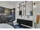 Modern bathroom featuring a double vanity, stylish mirrors, and a luxurious shower at 8747 Mesquite Row, Lone Tree, CO 80124