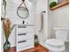 Bathroom with a modern vanity, round mirror, and shiplap accent wall at 8747 Mesquite Row, Lone Tree, CO 80124