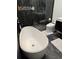 Spa-like bathroom featuring a standalone tub, sleek black fixtures, and elegant tile work at 8747 Mesquite Row, Lone Tree, CO 80124