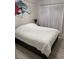 Bright bedroom showcasing a comfortable bed with white duvet and minimalist decor at 8747 Mesquite Row, Lone Tree, CO 80124