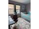 Cozy bedroom with a white crib, light pink walls, and natural light from large windows at 8747 Mesquite Row, Lone Tree, CO 80124