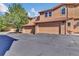 Exterior view of townhome featuring a two car garage, set beneath a red tiled roof at 8747 Mesquite Row, Lone Tree, CO 80124