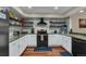 Modern kitchen with white cabinets, stone countertops, and hardwood floors at 8747 Mesquite Row, Lone Tree, CO 80124