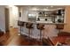 Kitchen and breakfast bar with modern seating and stainless steel appliances at 8747 Mesquite Row, Lone Tree, CO 80124