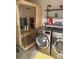 Well-equipped laundry room with washer, dryer, shelves, and a modern sauna at 8747 Mesquite Row, Lone Tree, CO 80124