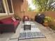 Relaxing patio area with modern outdoor furniture and a stylish patterned rug at 8747 Mesquite Row, Lone Tree, CO 80124