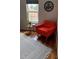 Inviting reading nook with comfortable red armchair, side table, and large patterned rug at 8747 Mesquite Row, Lone Tree, CO 80124