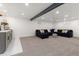 Finished basement features a wet bar, a large sectional sofa with stylish pillows, creating an inviting entertainment area at 9197 W Woodard Dr, Lakewood, CO 80227