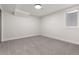 A clean and simple basement with a window providing natural light, complemented by neutral-toned carpet and walls at 9197 W Woodard Dr, Lakewood, CO 80227