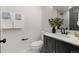 Well-lit half-bath with black vanity and fixtures for a sleek and modern look at 9197 W Woodard Dr, Lakewood, CO 80227