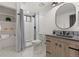 Contemporary bathroom with stylish vanity, open shelving, walk-in shower, and modern fixtures for a spa-like feel at 9197 W Woodard Dr, Lakewood, CO 80227