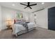 Inviting bedroom with a ceiling fan, natural light, and an ensuite bathroom for privacy at 9197 W Woodard Dr, Lakewood, CO 80227
