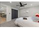 Bedroom featuring ample natural light, ceiling fan and access to open concept kitchen/dining at 9197 W Woodard Dr, Lakewood, CO 80227