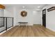 A stylish entryway featuring hardwood floors, modern decor, and convenient coat rack, with views of the staircase at 9197 W Woodard Dr, Lakewood, CO 80227