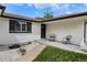 Close-up of a charming front porch with a seating area and attractive architectural details and landscaping at 9197 W Woodard Dr, Lakewood, CO 80227