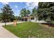 This charming home has a large front yard, an attached garage, and lovely landscaping at 9197 W Woodard Dr, Lakewood, CO 80227