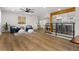 Open concept living room featuring hardwood floors, natural light, modern decor, and a partial view of the kitchen at 9197 W Woodard Dr, Lakewood, CO 80227