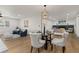 Comfortable living area connected to dining space, featuring a fireplace and ample seating at 9197 W Woodard Dr, Lakewood, CO 80227