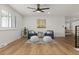 Bright and airy living room with hardwood floors, stylish furniture, and plantation shutters for natural light control at 9197 W Woodard Dr, Lakewood, CO 80227