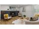 Bright living room featuring a fireplace, wood floors, comfortable seating, and modern decor at 9197 W Woodard Dr, Lakewood, CO 80227