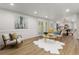 Bright and airy living room with an open floorplan, wood floors, and plenty of natural light at 9197 W Woodard Dr, Lakewood, CO 80227