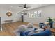 Spacious living area with hardwood floors, modern furnishings, and large windows offering plenty of sunlight at 9197 W Woodard Dr, Lakewood, CO 80227