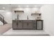 Modern wet bar area with custom cabinets, open shelving, wine storage, and a sleek countertop with a sink at 9197 W Woodard Dr, Lakewood, CO 80227