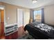 Bedroom with hardwood floors, a black bedspread, and a bright window with view outside at 85 Yank Way, Lakewood, CO 80228