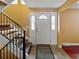 Bright entryway with staircase and a decorative front door featuring side windows at 85 Yank Way, Lakewood, CO 80228