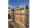 Metal gate over a wooden fence at 85 Yank Way, Lakewood, CO 80228