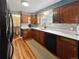 Well-lit kitchen with white countertops, wood cabinets, and stainless steel appliances at 85 Yank Way, Lakewood, CO 80228