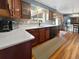 Functional kitchen featuring white countertops, wood cabinets, and tile backsplash at 85 Yank Way, Lakewood, CO 80228