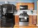 Modern kitchen featuring stainless steel appliances, wood cabinets, and light countertops at 85 Yank Way, Lakewood, CO 80228